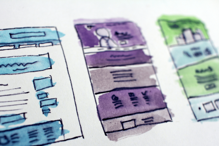 Watercolor illustration of three webpage wireframes side by side, sketched in blue, purple, and green.