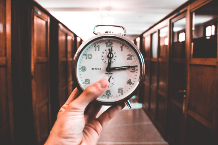 A hand holding a clock