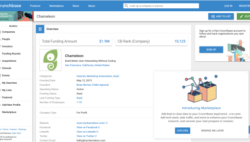 A floating Crunchbase feature announcement popup in the lower-right corner of a company profile page, with an illustration and explore or dismiss options.