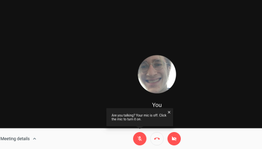 A Google Hangouts tooltip prompting users to unmute their microphone after speaking while muted.
