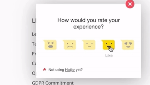 A Hotjar feedback widget asking users to rate their experience, showing five emoji face options with the cursor hovering on 'Like.'