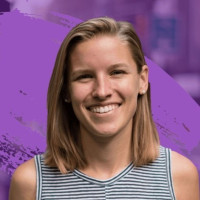 Headshot of Breezy Beaumont, external blog author, smiling against a purple background.