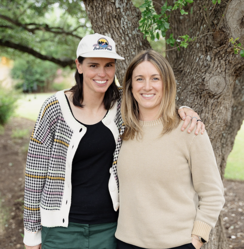 Two Chameleon team members smiling together outdoors at a team gathering.